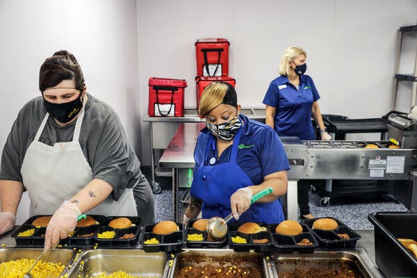 Nicole Carey, left, and Tameika Drye, center, prepared meals for delivery to seniors and others at Cabarrus Meals on Wheels in Concord, N.C.